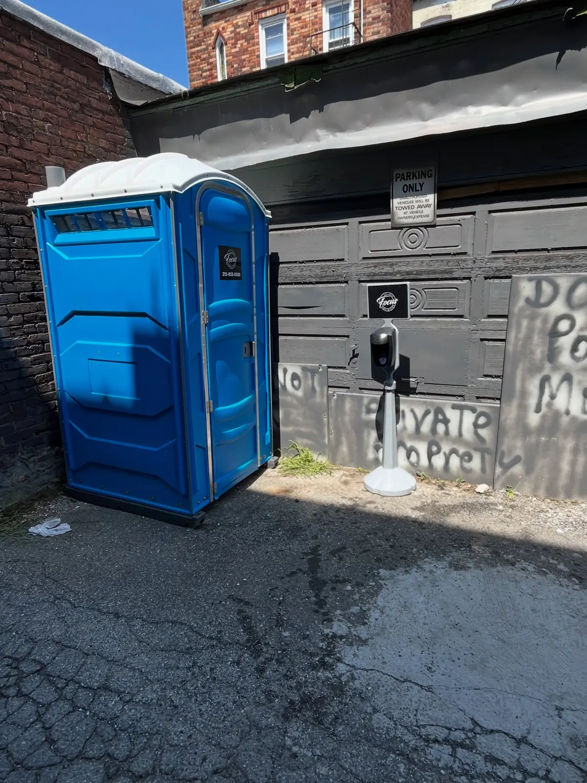 Blue porta potty placed at a work site