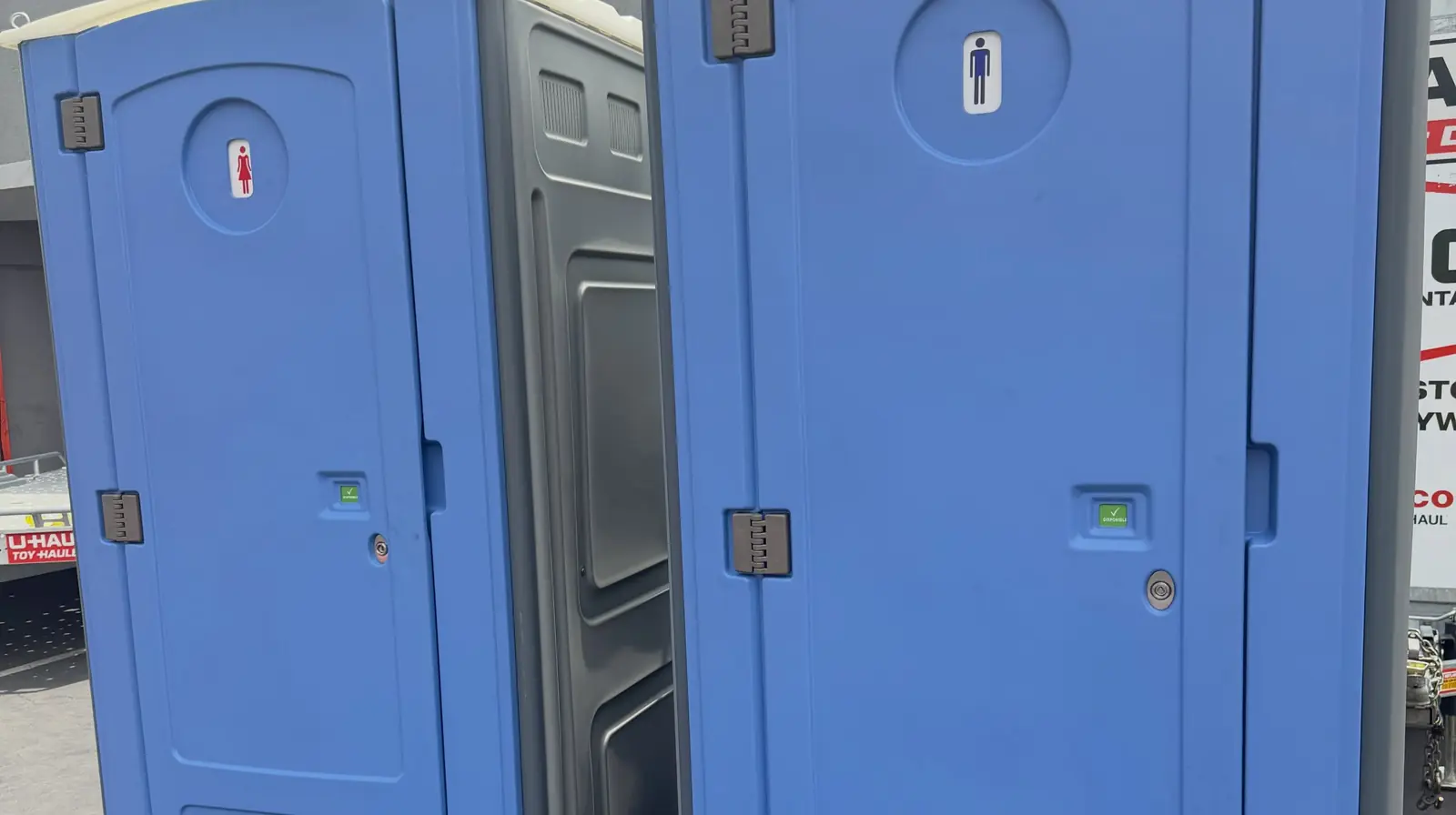 Two blue standard porta potties side by side
